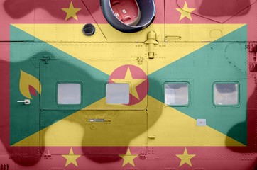 Grenada flag depicted on side part of military armored helicopter closeup. Army forces aircraft conceptual background