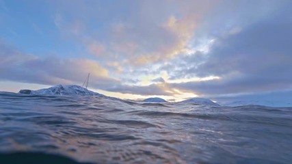 Wall Mural - beautiful norway snowy fjord shot from water surface with underwater transition