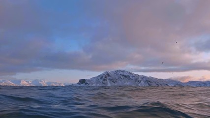 Wall Mural - norway snowy fjord shot from water surface with underwater transition