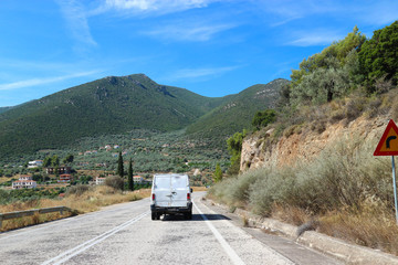 Car on a scenic greek rural road in the mountains of Peloponnese, Greece