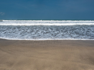 Wall Mural - Indonesia, november 2019: The Kuta beach in Bali. White sand and blue ocean