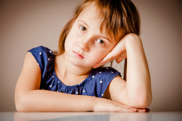 Portrait of bored little cute young gir showing very lazy unhappy and tired gesture