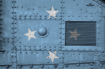 Micronesia flag depicted on side part of military armored tank closeup. Army forces conceptual background