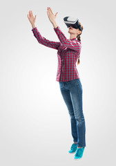 Wall Mural - Young woman wearing virtual reality glasses