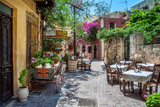 Fototapeta Uliczki - Courtyard of the tavern in the port of Chania