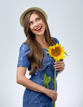 Woman Holding One Sunflower And Looking Up.