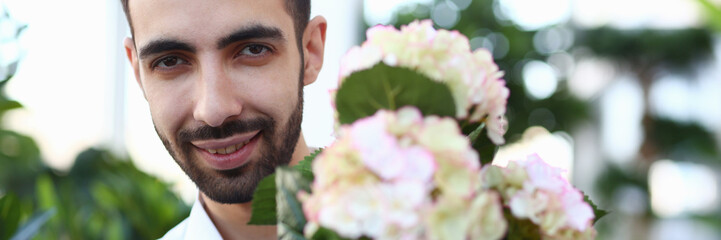 Bearded Male Florist with White Blooming Hydrangea