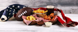 Fototapeta  - chicken wings, fries and onion rings for football on a table. Great for Bowl Game party