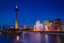 Dusseldorf, Germany - Blue Hour Evening View Around The World In Dusseldorf At The Rhine River, The TV Tower And The Iconic Harbor Buildings At Night