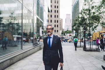 Wall Mural - Confident mature man walking down street