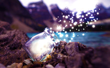 Magic Dust And Lights Flowing From Tiny Glass Mason Jar In Mountain Outdoor Scenic Landscape