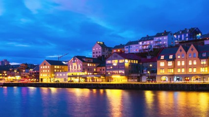 Wall Mural - Kristiansund, Norway. View of city center of Kristiansund, Norway during the cloudy night with colorful sky. Time-lapse of port with historical buildings