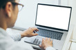 © panitan - mockup image blank screen computer with blank white background for advertising text,hand man using laptop contact business search information on desk at home office.marketing and creative design