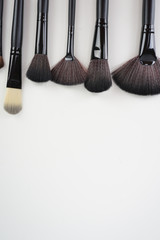 Wall Mural - A set of a black make up brushes over the white background