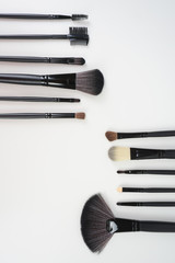 Wall Mural - A set of a black make up brushes over the white background