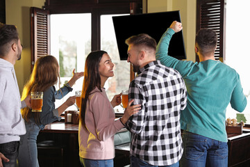 Wall Mural - Group of football fans in sport bar