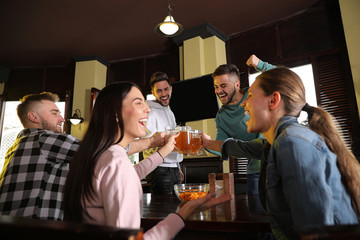 Sticker - Group of friends celebrating victory of favorite football team in sport bar