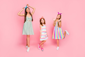 Sticker - Full size photo of pretty ladies with bright headbands enjoying posing wearing dress skirt isolated over pink background