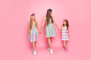 Sticker - Full length photo of lovely girls with headbands holding hands looking wearing skirt dress isolated over pink background