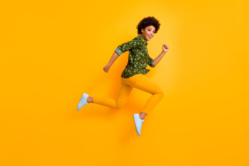 Canvas Print - Full size photo of crazy dark skin curly lady jumping up high rushing fast discount shopping black friday low prices wear green dotted shirt pants shoes isolated yellow color background