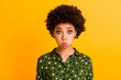 © deagreez - Photo of beautiful funny dark skin lady holding full mouth of air not breathing crazy childish person wear green dotted shirt blouse isolated yellow color background