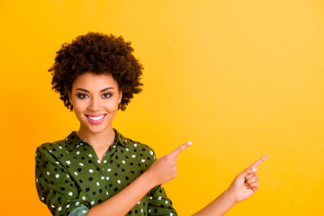 Canvas Print - Photo of funny toothy dark skin wavy lady indicate fingers empty space advising buyer new product low price wear trendy green dotted shirt blouse isolated yellow color background