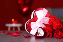 Marry Me Concept, Wedding / Engagement Ring With Red Candles, Roses Bouquet, Heart Shaped Air Balloon. Happy St. Valentine's Day Concept. Close Up, Copy Space, Front View
