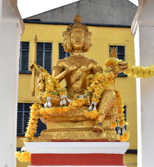 Sticker - Beautiful golden Buddha statue on a shrine outside a temple