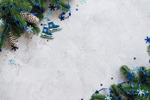 Christmas Of New Year Background With Fir Branches And Blue Baubles On A Gray Concrete.
