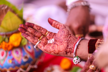 Traditional indian wedding ceremony, groom holding hand in bride hand