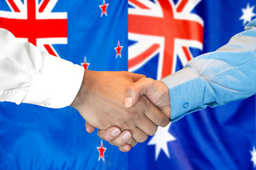 Wall Mural - Handshake on New Zealand and Australia flag background.