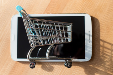 Shopping cart with phones. Online shop for smartphones or internet web store concept