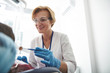 © Yakobchuk Olena - Cheerful nice female dentist treating teeth with pleasure