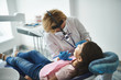 © Yakobchuk Olena - Young lady is being examined by dental professional