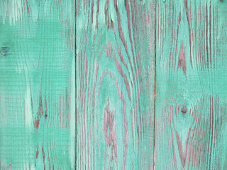  texture of bright green vintage wooden fence with peeling paint  