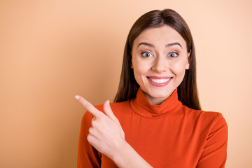 Wall Mural - Photo of charming attractive beautiful fascinating secretary pointing at something away while being surprised wearing red turtleneck isolated pastel background
