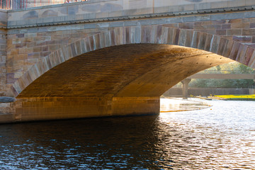 Light underneath a stone bridge.