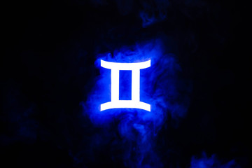 blue illuminated Gemini zodiac sign with colorful smoke on background