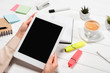 © LIGHTFIELD STUDIOS - cropped view of woman holding digital tablet at workplace with office supplies and coffee