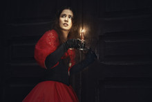 Mysterious Woman In A Red Victorian Dress By The Old Door