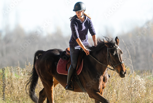 Zdjęcie: Young girl riding a horse Young girl riding a horse