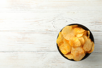 Wall Mural - Potato chips. Beer snacks on white wooden background, space for text. Top view