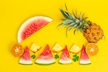 Wall Mural - exotic tropical fruits, pineapple, orange, watermelon isolated on a yellow background