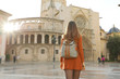 Tourism in Valencia. Back view of beautiful girl visiting Valencia Cathedral on sunny day. Holidays in Spain.