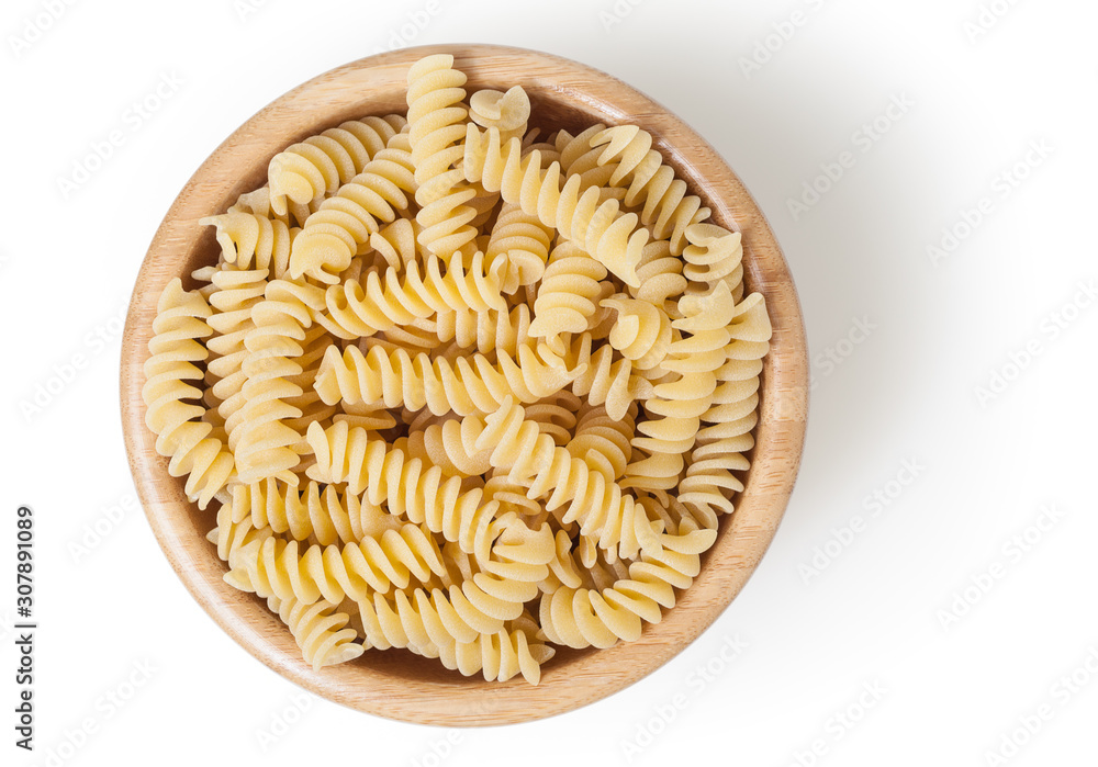 Uncooked fusilli pasta in wooden bowl isolated on white background with clipping path - obrazy, fototapety, plakaty 