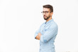 © Mangostar - Serious suspicious guy with arms crossed looking at camera. Handsome young man in casual shirt and glasses standing isolated over white background. Male portrait concept