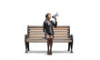 © adam121 - Young woman with megaphone on wooden bench