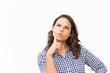 © Mangostar - Pensive female customer touching face and thinking hard. Young woman in casual checked shirt standing isolated over white background. Decision making or advertising concept