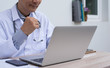 © tippapatt - Doctor working on laptop computer