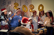 © luckybusiness - Business team celebrating new 2020 year in office